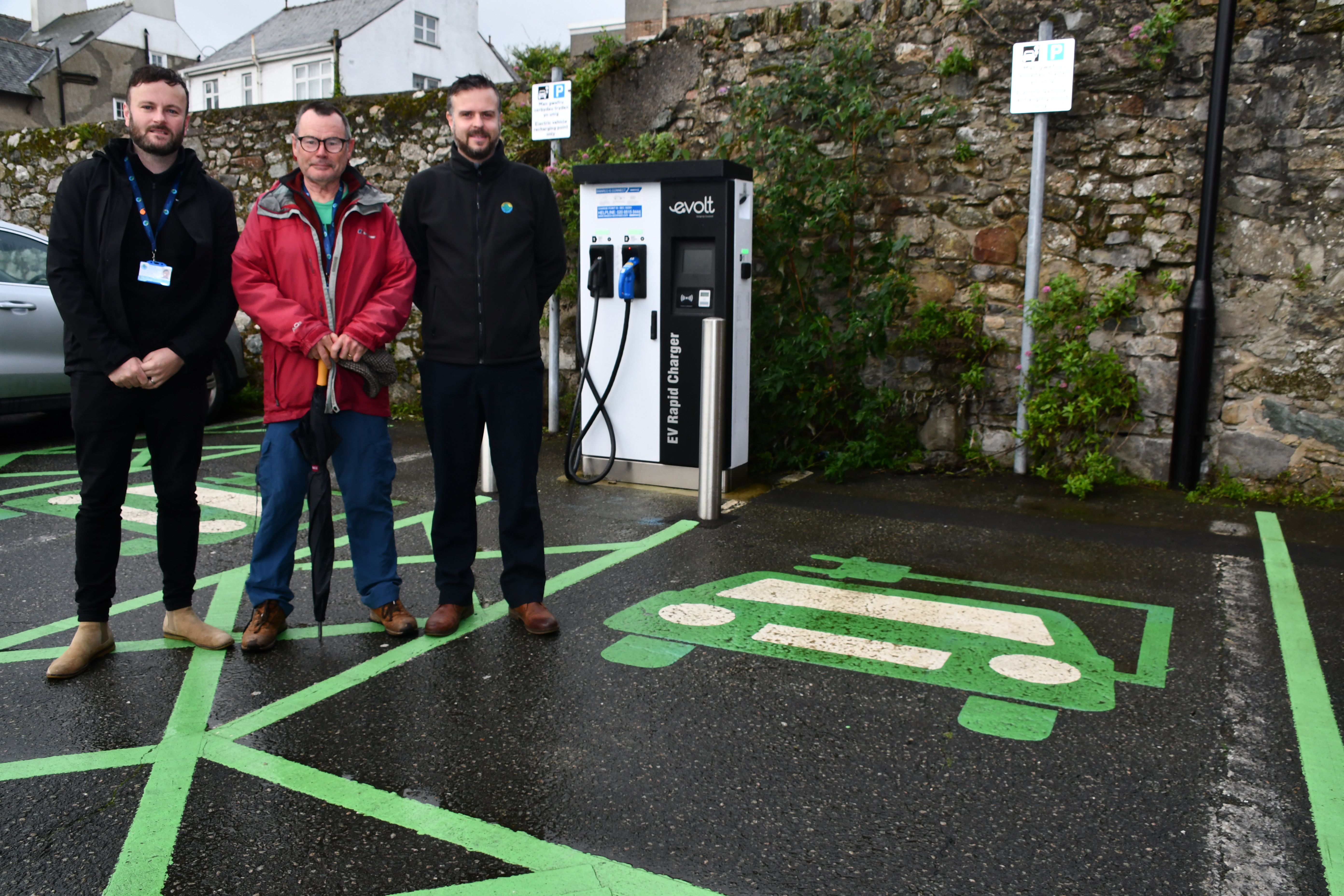 Council staff at an electric charging point