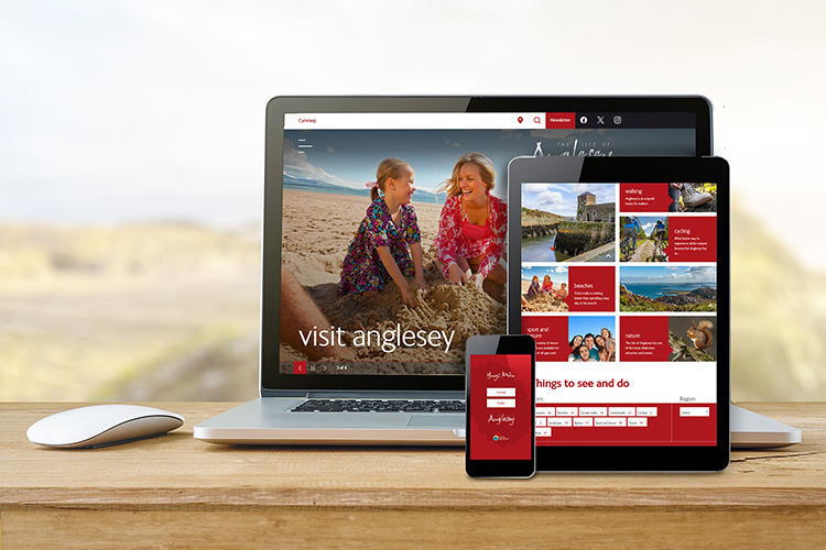 Visit Anglesey website showing on a laptop, tablet and smart phone